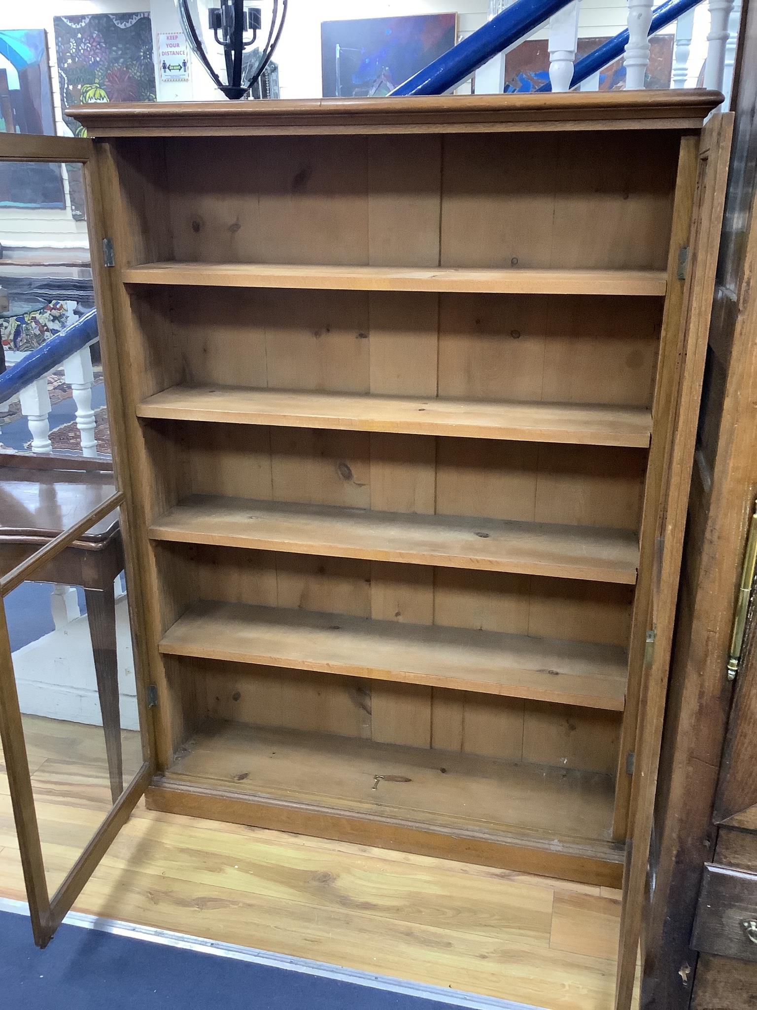 A late Victorian oak two door glazed bookcase